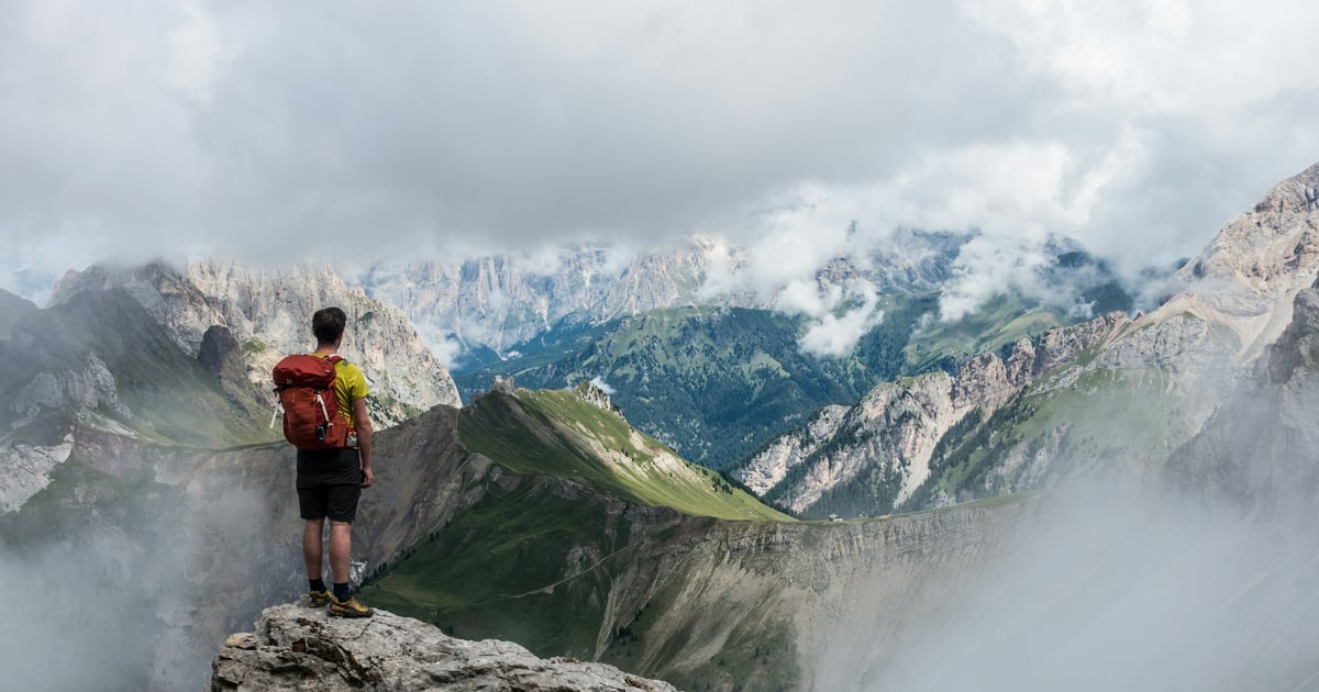 Man standing on rock looking at beautiful mountains - Photo by Lucas Clara on Unsplash
