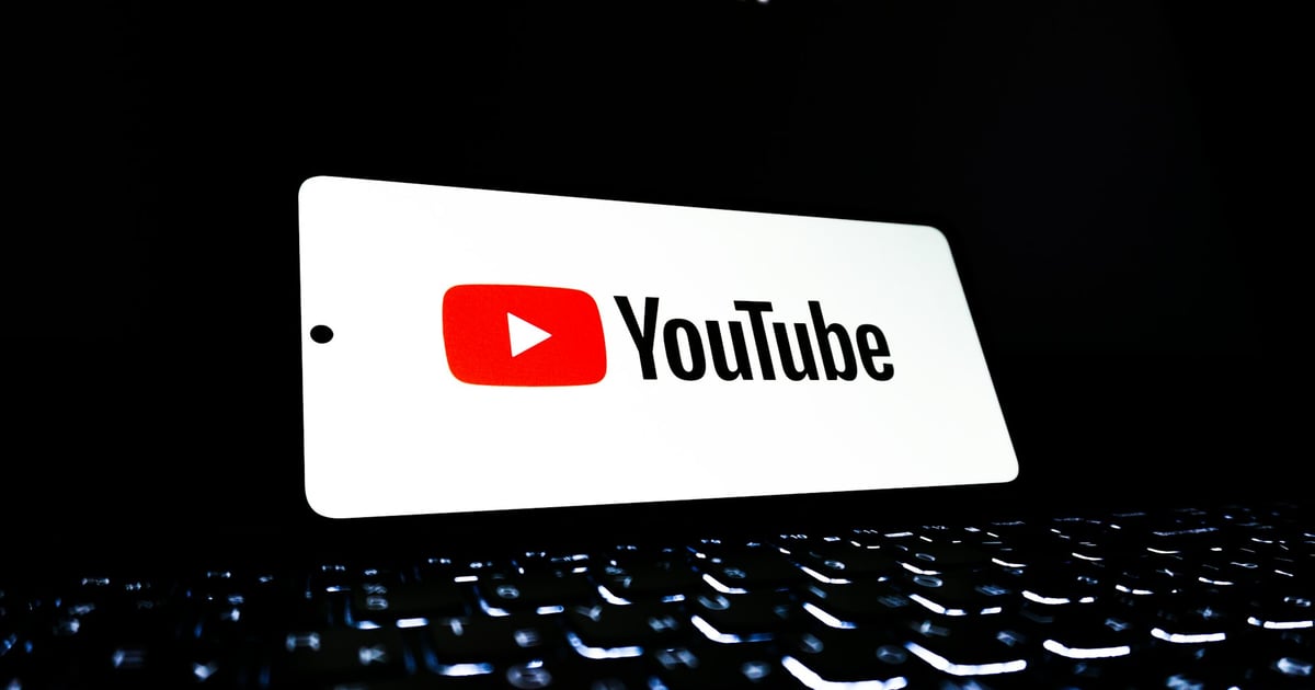 Keyboard with background light and a phone with the Youtube logo.