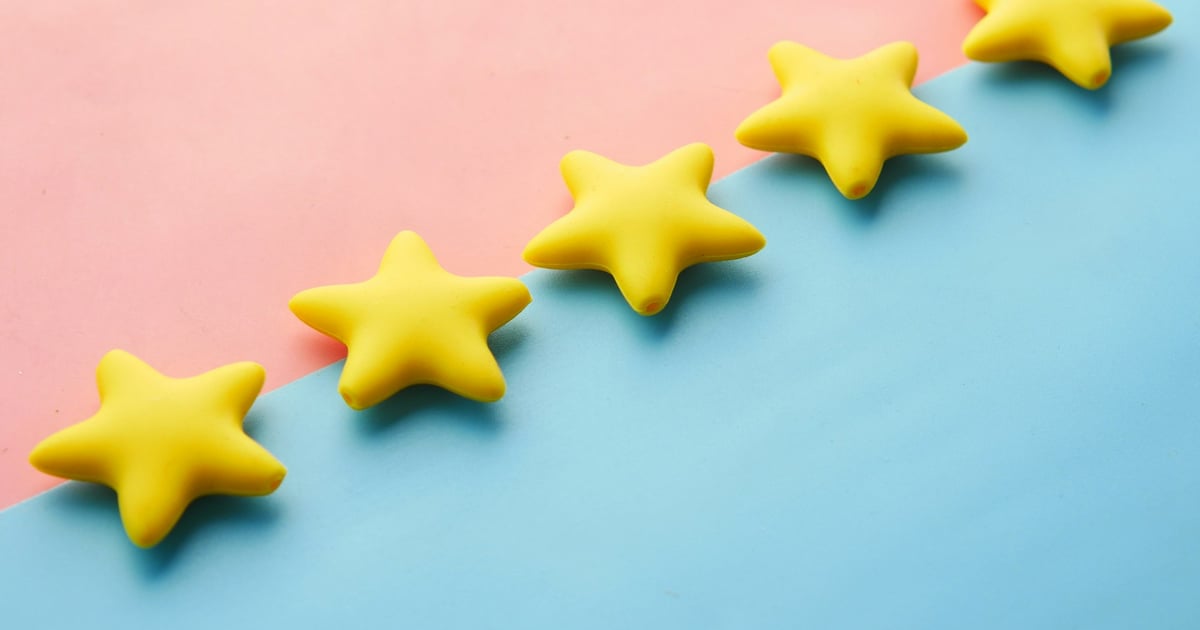 Five yellow star-shaped objects placed diagonally on a pink and blue background.