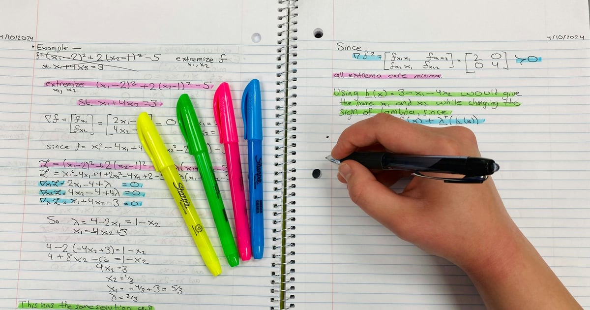 Person taking notes with pen and colorful highlighters